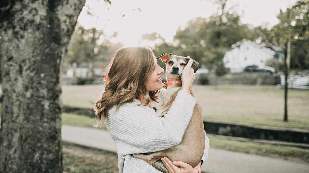 Woman holding and cuddling a dog